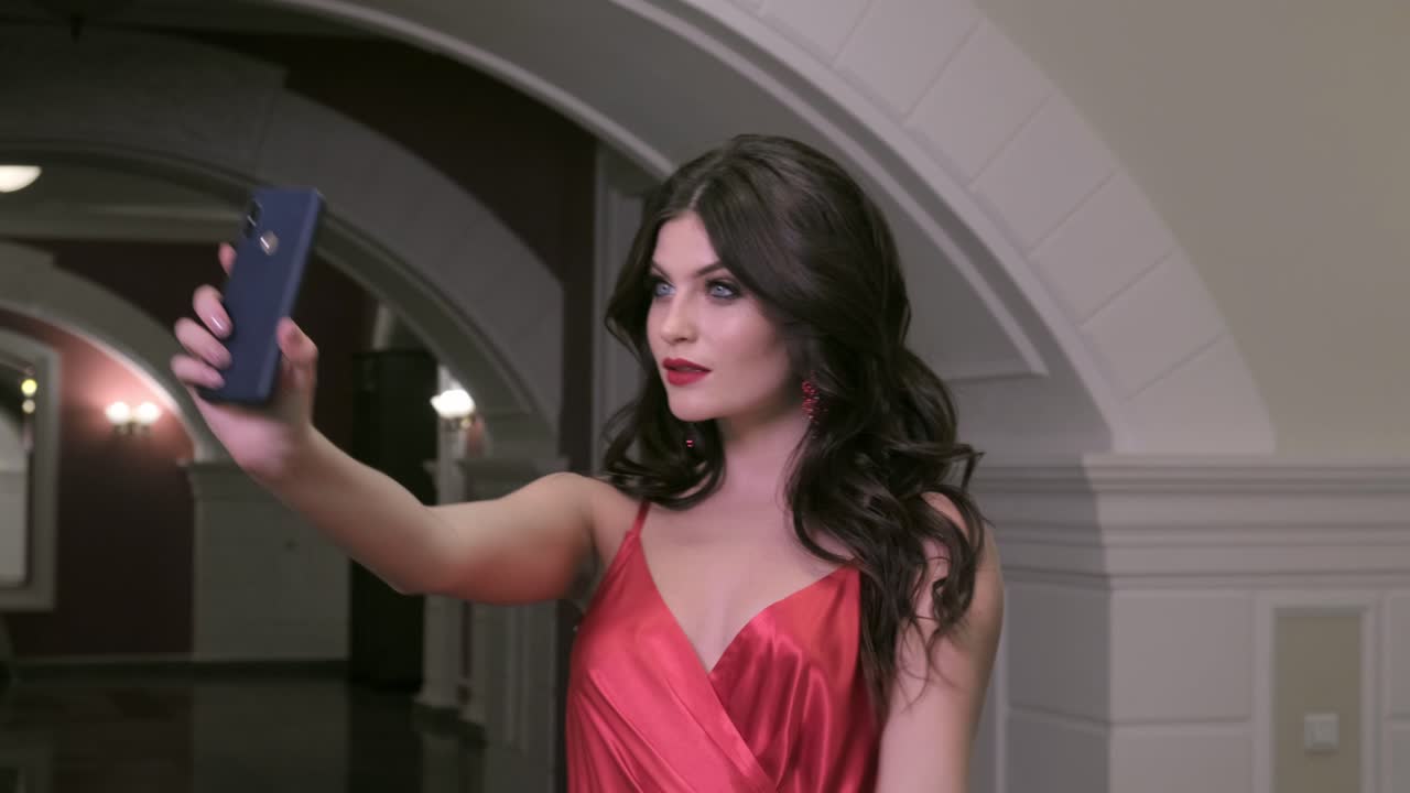 Woman Taking Selfie in a Hotel Hallway