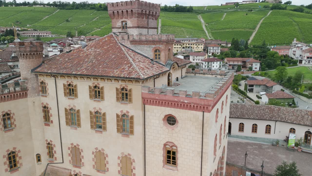 Barolo Castle in Langhe Wine Region, Cuneo, Piedmont, Italy. 4K Aerial view of the village and the vineyards. Circling to the left, close to the castle.