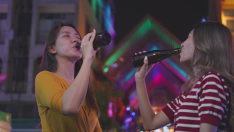 two friends enjoying a night out at a night market