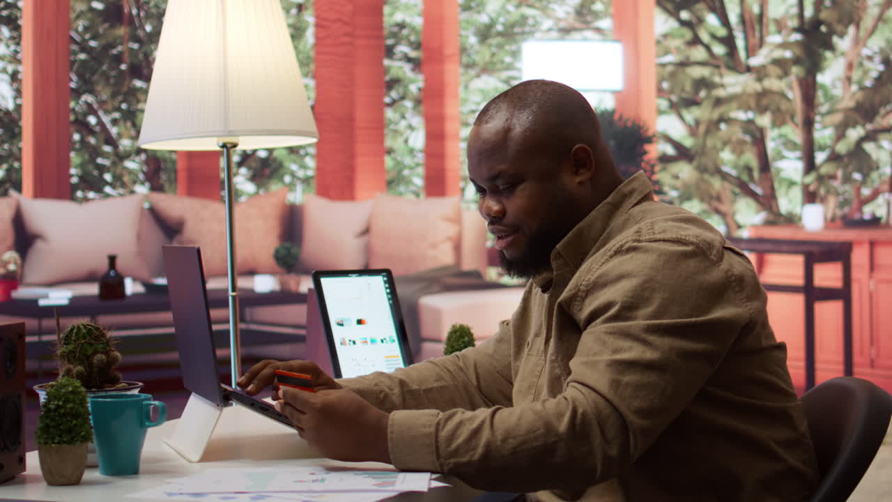 Business owner makes a payment with his card for online shopping at his home