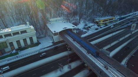 aerial view metro train moving on outdoot railway. winter highway in city