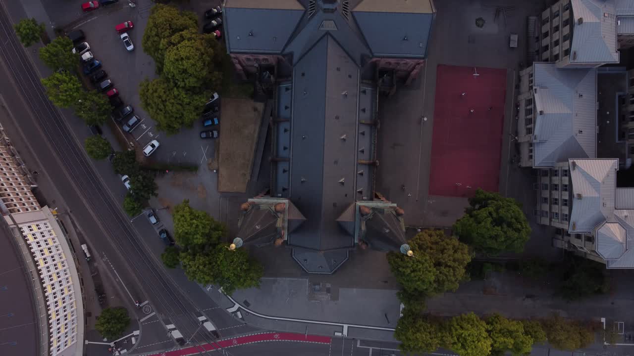 camera movement From top to back looking down on the church which looks like a cross built in the shape of a cross