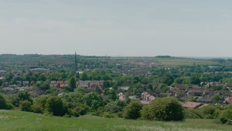 Grantham-Town-Lincolnshire-UK-East-Midlands-crop-fields-view-in-the-distance-of-the-town-Summer-day-wind-blowing-grass-and-trees-and-crops-high-view-point-houses-in-view-and-st-wulfram's-church