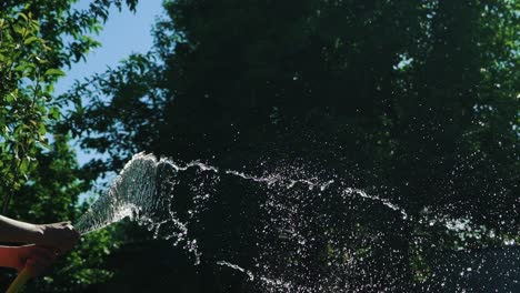 flow of clean water from a rubber hose. summer gardening. slow motion.