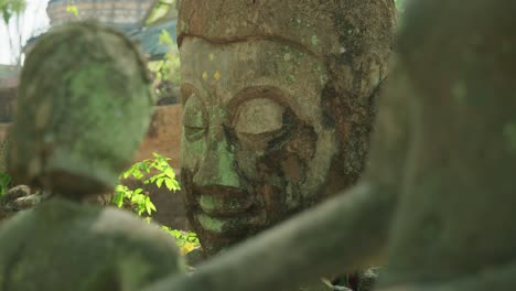 4k cinematic slow motion footage of ruins of buddhist statues at wat umong temple in chiang mai, northern thailand on a sunny day