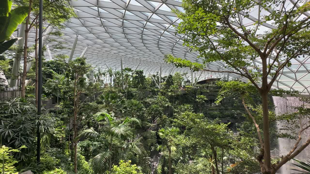 Singapore Jewel - Tree Canopy geometrical glass ceiling - Indoor Waterfall Vortex to far right at Changi Airport