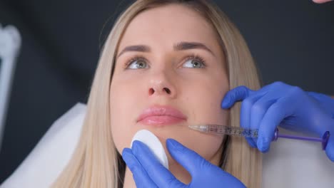 woman receiving cosmetic facial injection
