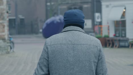 Man-walking-down-the-streets-of-Rotterdam,-The-Netherlands