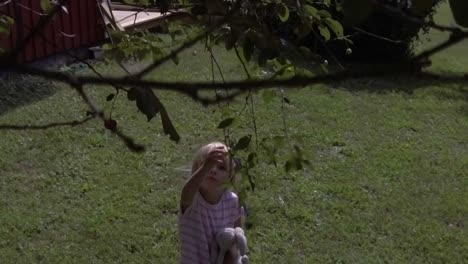 slow motion shot of girl trying to pick cherry berries from tree in high wind, masking effect possible