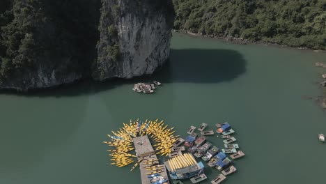 rising aerial tilt: yellow rental kayaks await tourists in vietnam