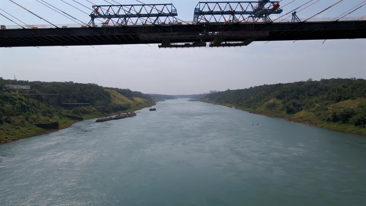 Integration Bridge Paraguay Brazil border under construction infrastructure, aerial drone over river