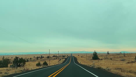 driving on a long, straight road in the countryside