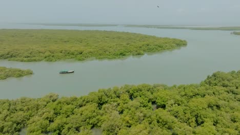 aerial view capturing landscape of the indus river delta with a boat sailing on river in foreground near karachi pakistan