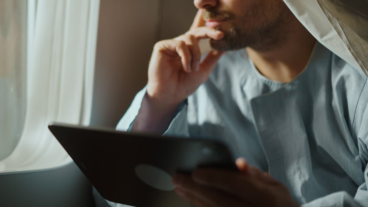 Middle Eastern man on an airplane