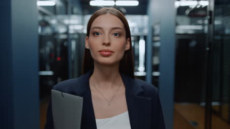 Cheerful-lady-going-on-meetup-in-business-center.-Woman-looking-around-in-office