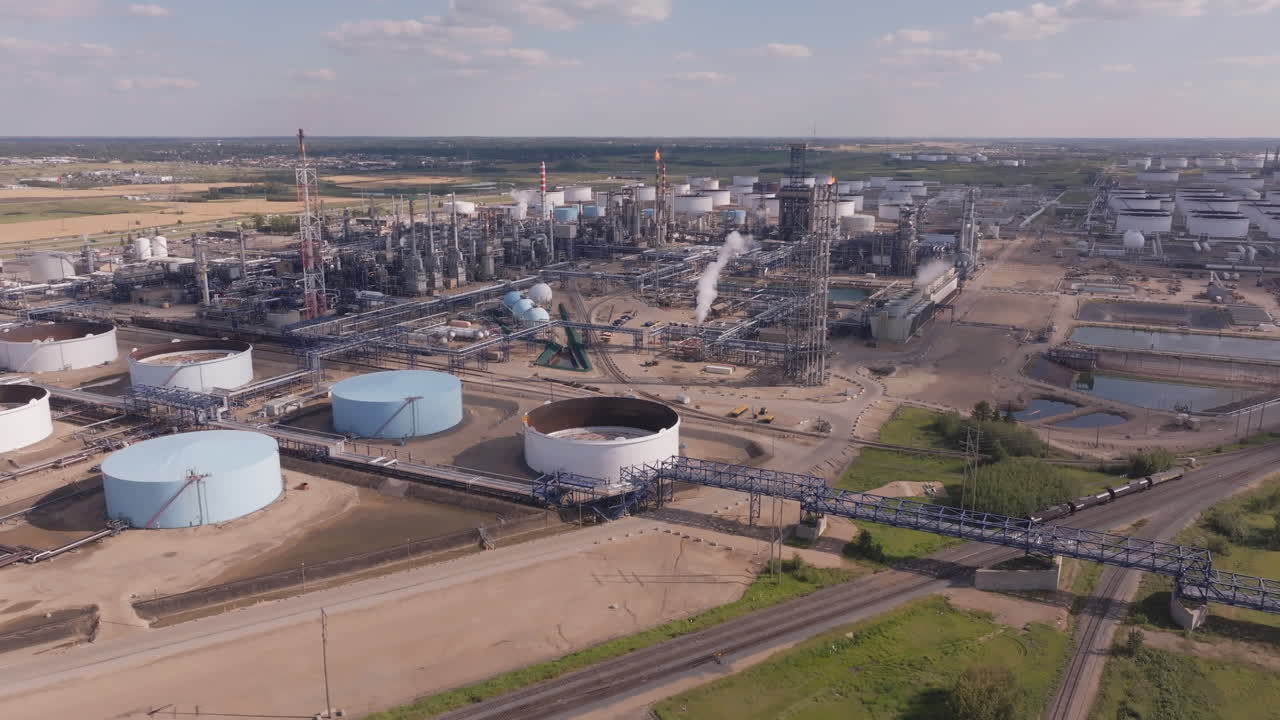 Aerial view of vast industrial refinery under a clear sky