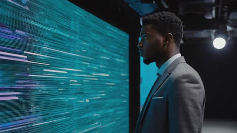 man looking at futuristic data screen