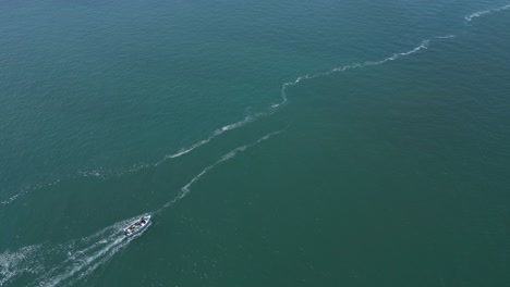 tourists exploring the coast of portugal by boat on a sunny blue day