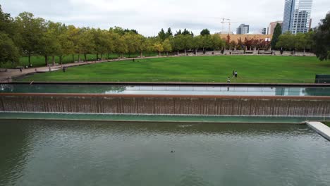 Vibrant-Bellevue-Downtown-Park-aerial-drone-flight-captures-serene-water-fountain-and-lush-greenery