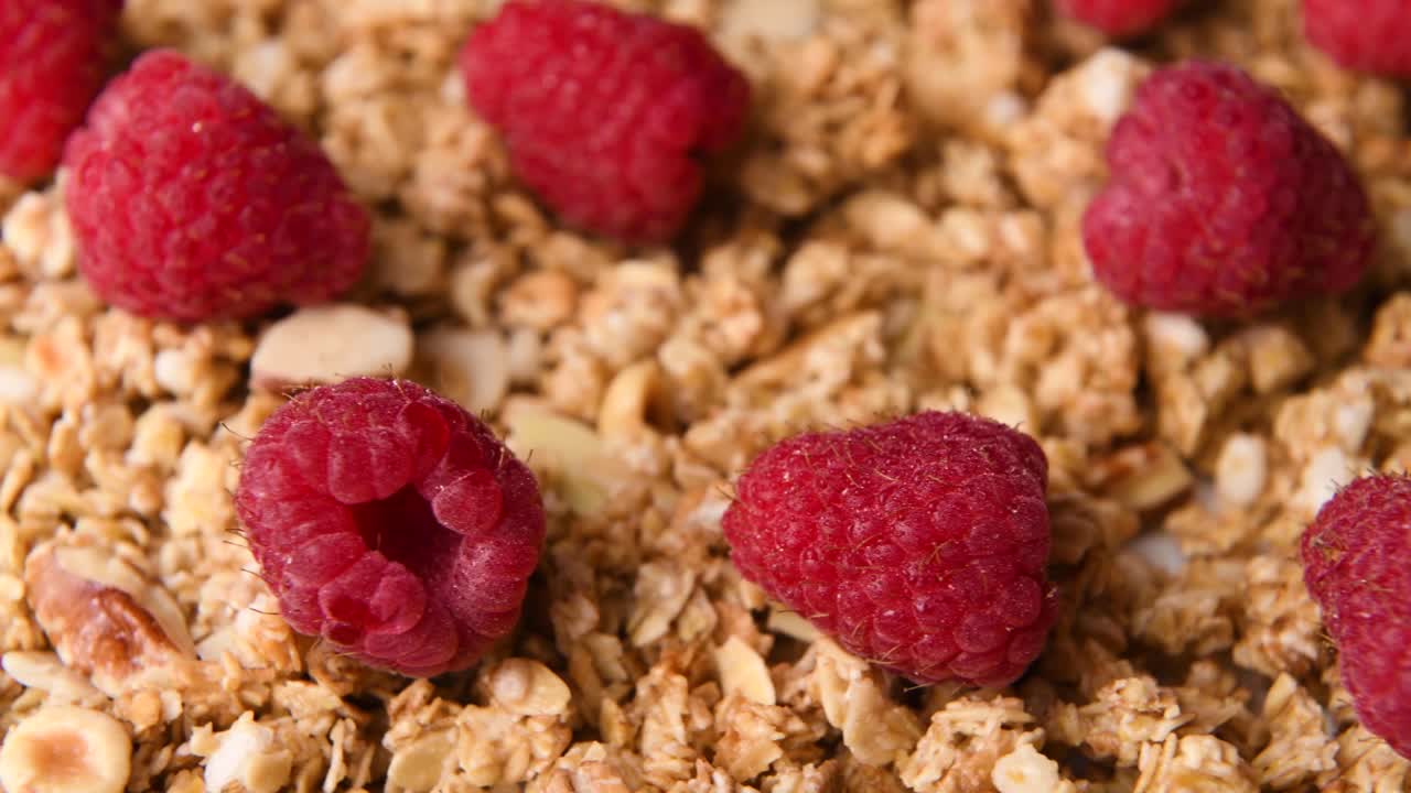 Close up detail shot of granola with raspberries