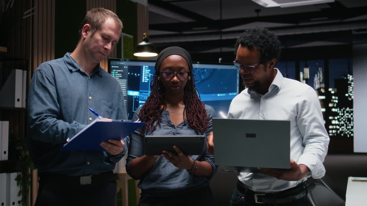 Diverse Business Team Collaborating on Project in Modern Office at Night
