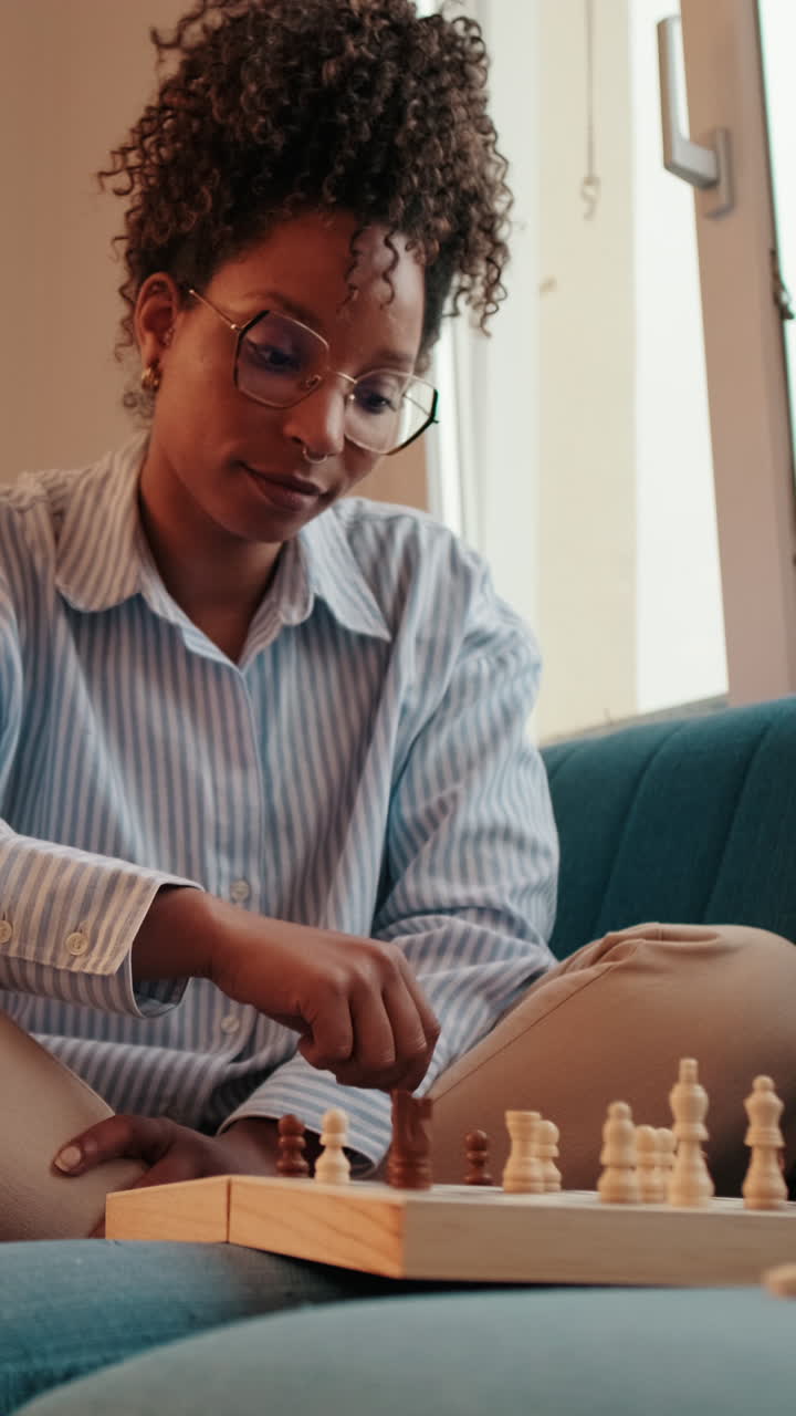 Woman Plays Chess on Couch