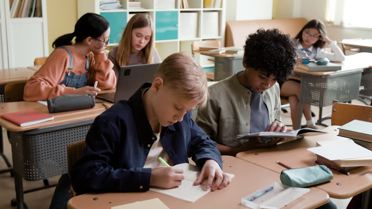 Students studying at their desks in a classroom