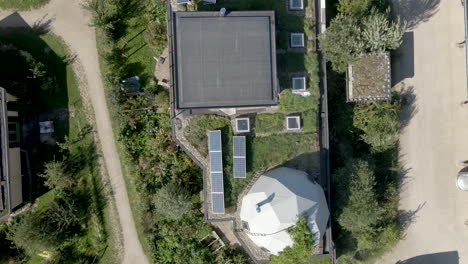 Top-down-aerial-of-earthship-rooftops-filled-with-solar-panels