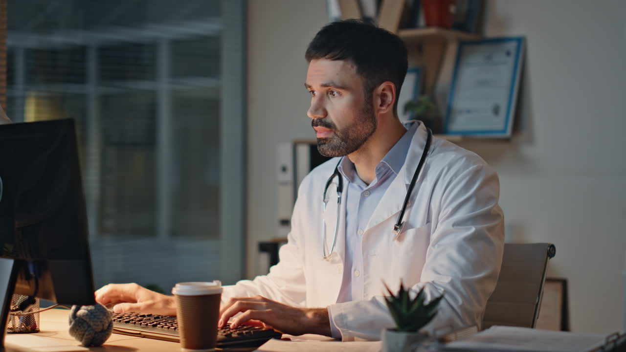 Doctor checking medical documents during night shift. Closeup tired medic drink