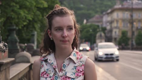 Girl-walking-in-Prague-street-and-looking-around,-front-closeup-view-of-head-or-face