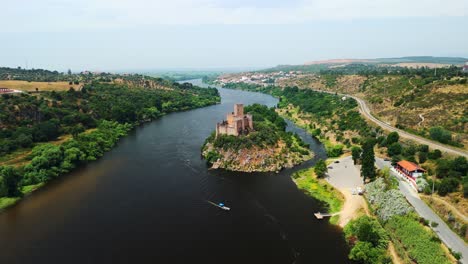 drone pull-back ascend reveals castelo de almourol on rio tejo, tancos, portugal