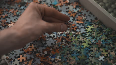Hand-trying-find-the-missing-piece-to-a-puzzle