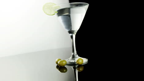 chevron pattern design over cocktail glass with lime wedge against black background