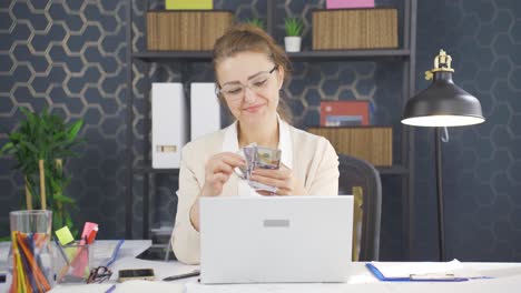 Business-woman-counting-money-looking-at-camera.