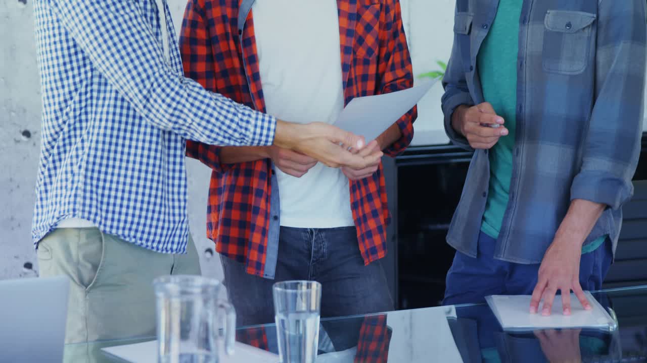 Center man reading doc while left man passing sheet in business meeting causing social icons rising