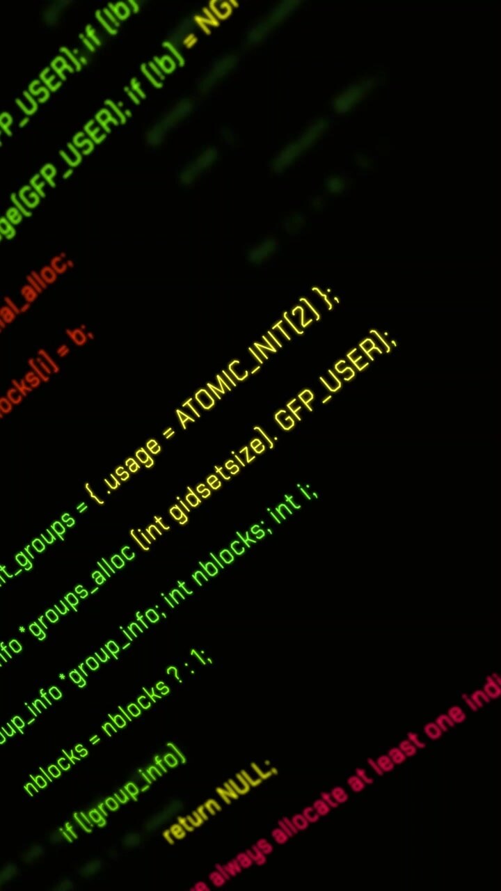 Scrolling C Programming Code on a Dark Computer Screen
