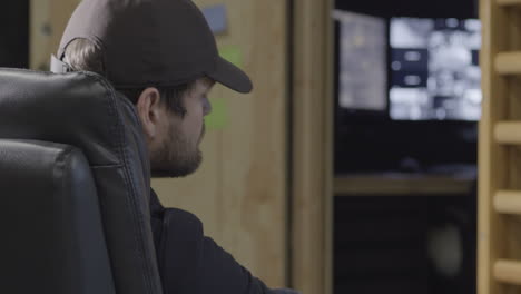 male man guard sleeping on night shift with cctv monitors on background, closeup