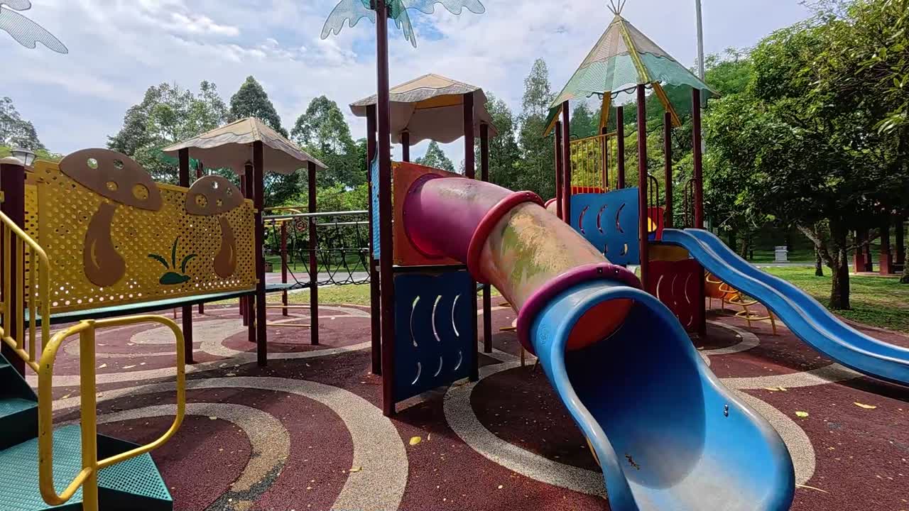 A vibrant public playground for children in a beautiful tropical park. Sunny weather enhances the cheerful outdoor atmosphere