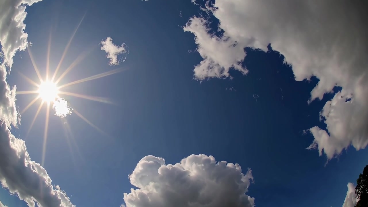 Time-lapse di sole luminoso e nuvole soffici nel cielo blu