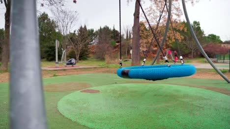 empty big swing in a children playground during covid-19 coronavirus pandemic lockdown