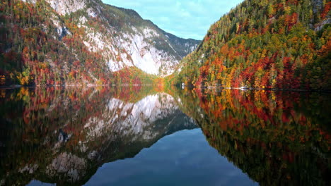 autumn lake reflection: colorful mountain and trees in toplitz lake, austria