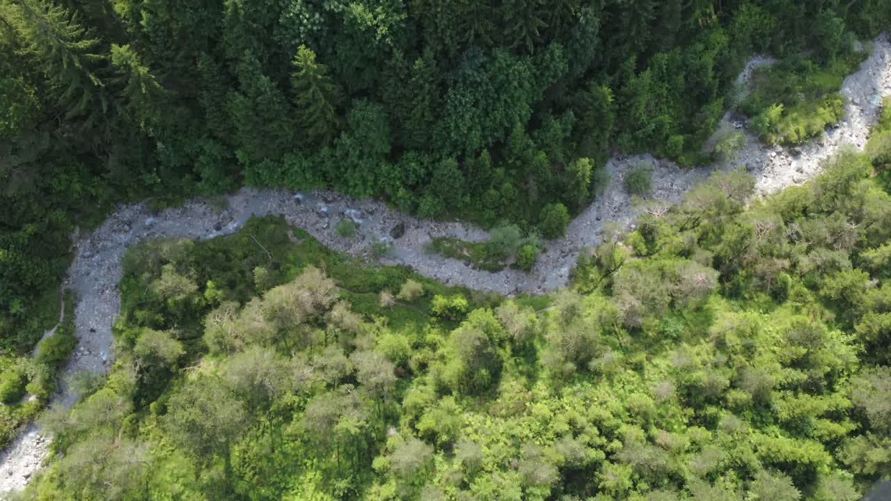 Drone footage gliding over a scenic mountain gap in Tyrol, Austria. The video highlights natural symmetry, alpine landscape, and immersive aerial perspective