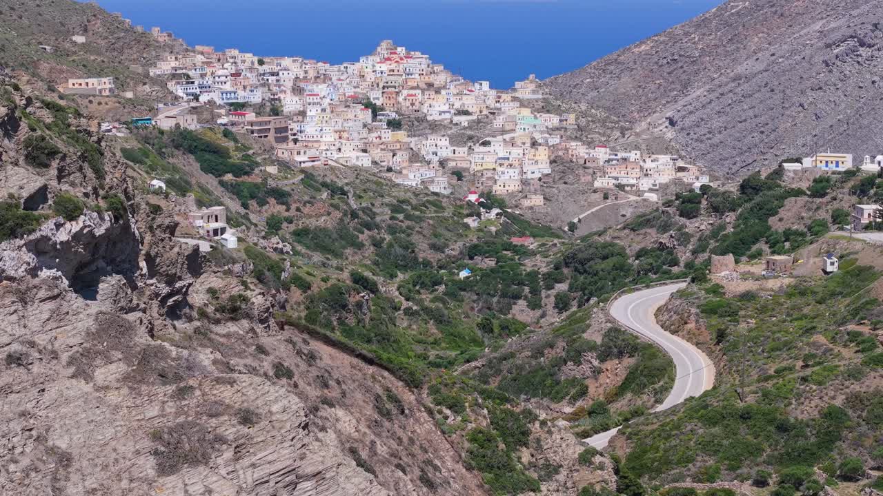 Drone footage following an off-road car heading toward the traditional Olympos village of Karpathos, showcasing the island’s rugged terrain and scenic mountainous landscape