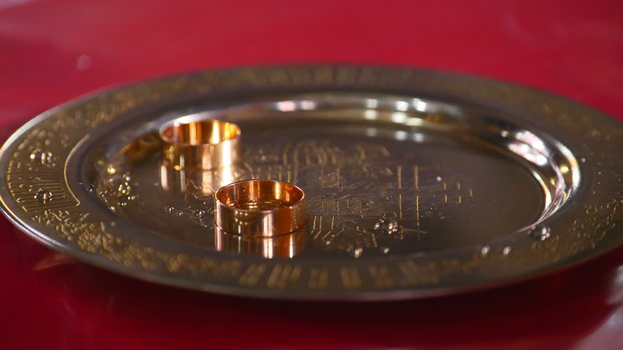 Classic gold wedding ring on a gold plate
