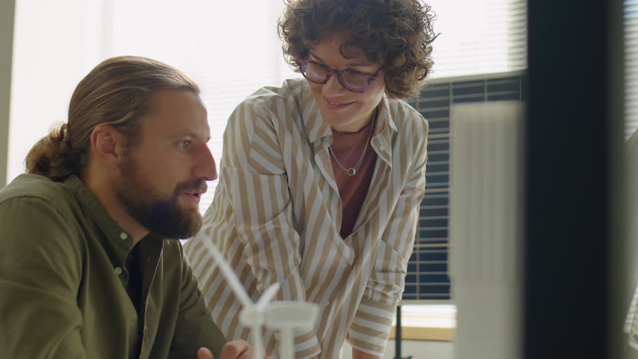 Renewable Energy Developers Discussing Project on Computer