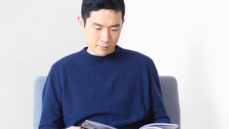 man looking at photo album in living room 4k