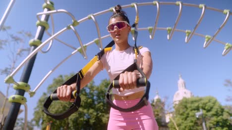 woman working out outdoors with resistance bands