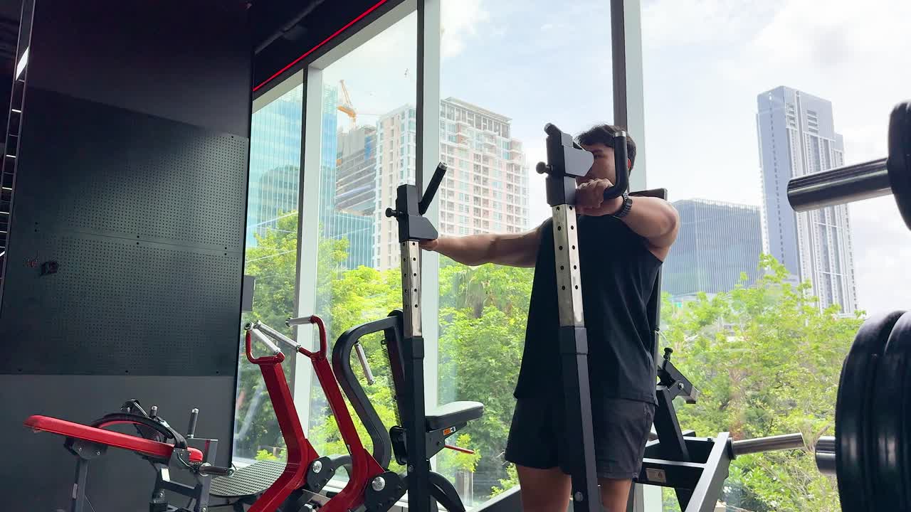 Man working out in a modern gym with city view