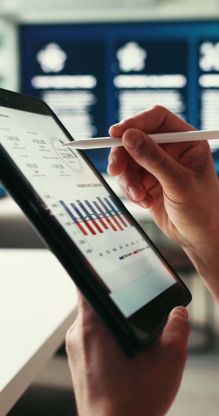 Business Professional Analyzing Financial Data on Tablet