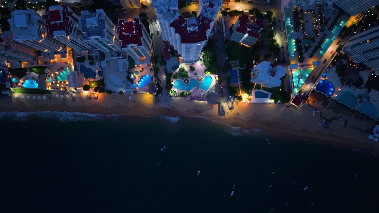 Drone capture showing Acapulco’s illuminated hotel area at night